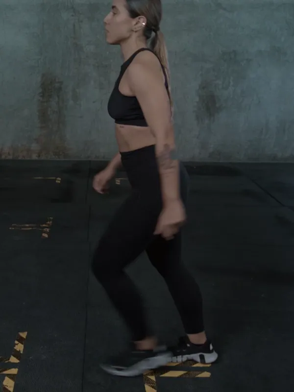 A woman stepping into a walking lunge